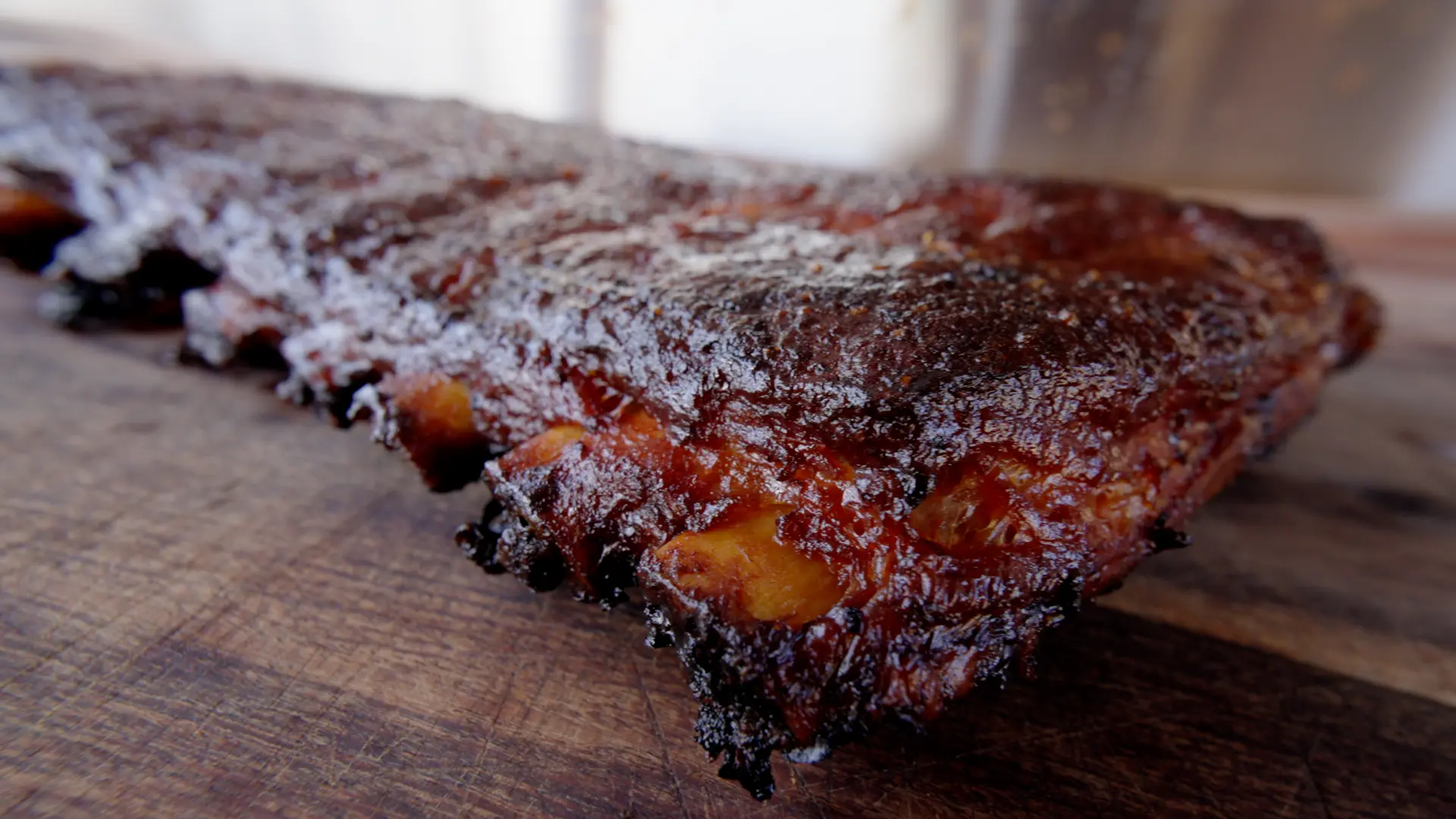 Ty holding a glazed rack of ribs