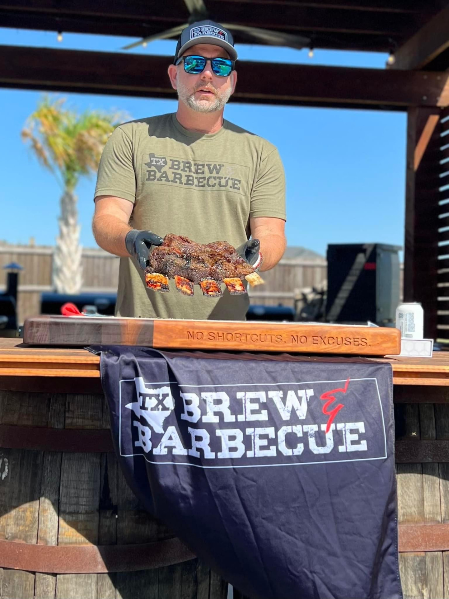Ty Sherrell serving ribs at an event booth