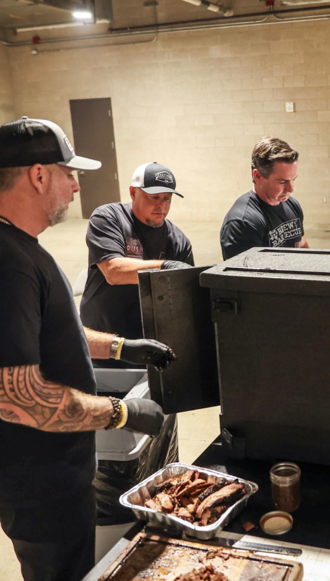 Ty Sherrell and the TX Brew & Barbecue crew plating sliced brisket at a corporate event